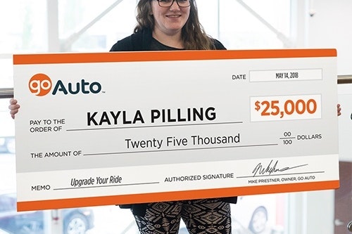 Photo of contest winner Kayla Pilling holding cheque
