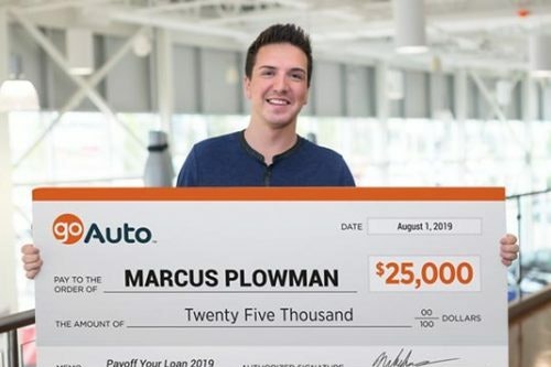 Photo of contest winner Marcus Plowman holding cheque