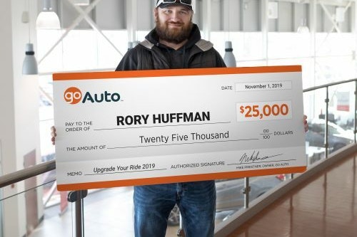Photo of contest winner Rory Huffman holding cheque