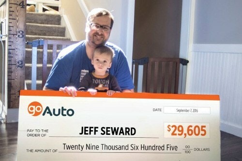 Photo of contest winner Jeff Seward holding cheque