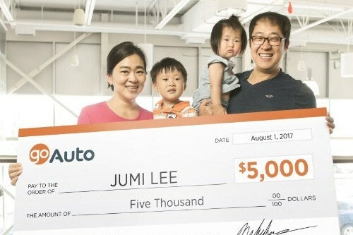 Photo of contest winner Jumi Lee holding cheque
