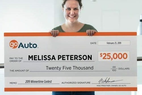 Photo of contest winner Melissa Peterson holding cheque