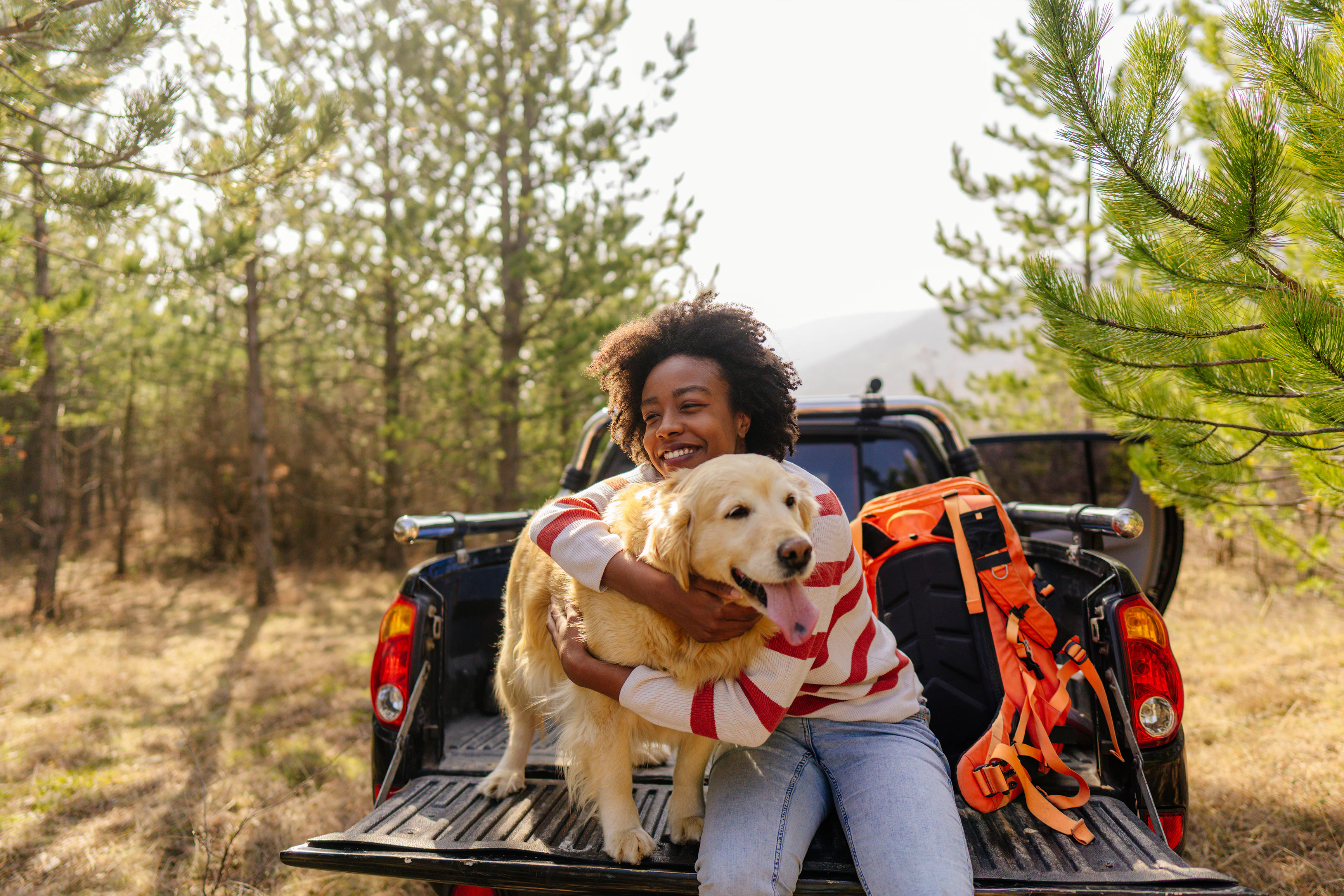 Woman with dog on truck bed
