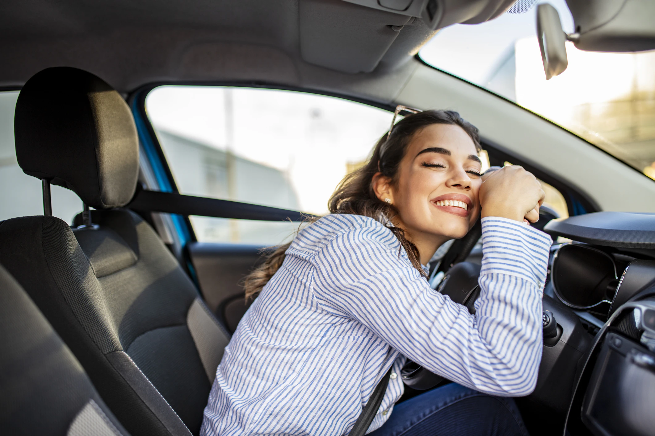 Happy driver enjoying comfortable seating in car interior
