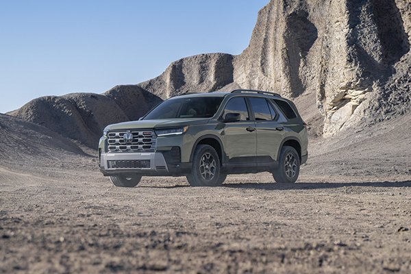 2026 Honda Pilot TrailSport parked on desert terrain with rocky cliffs