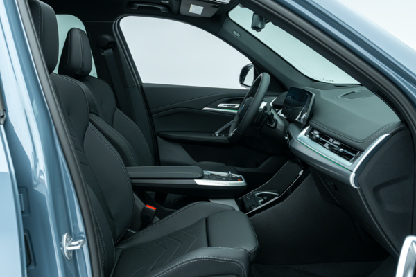 BMW X1 interior featuring black leather seats, dashboard, steering wheel and centre console.