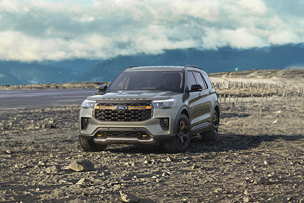 Ford Explorer parked on rocky terrain with mountains in background