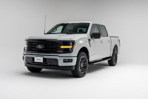 Front three-quarter view of a 2026 Ford F-150 XLT showing LED headlights, grille, alloy wheels and pickup truck profile.