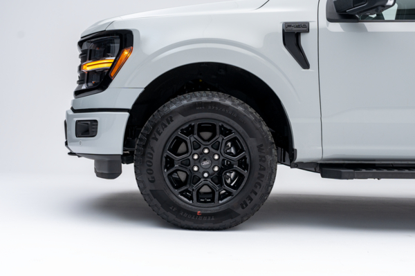 2026 Ford F-150 XLT front quarter view with LED headlights and all-terrain tire