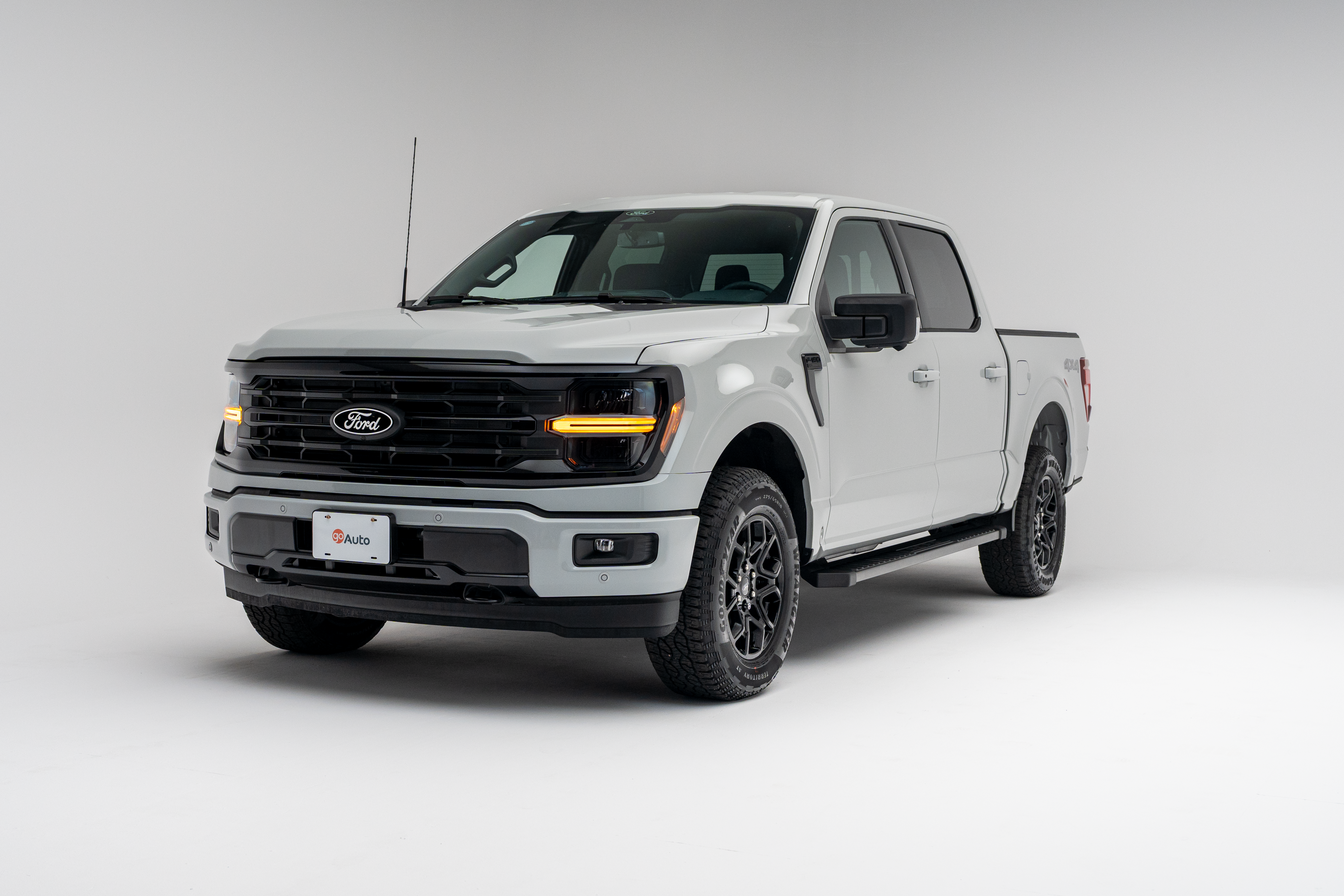 Front three-quarter view of a 2026 Ford F-150 XLT showing LED headlights, grille, alloy wheels and pickup truck profile.
