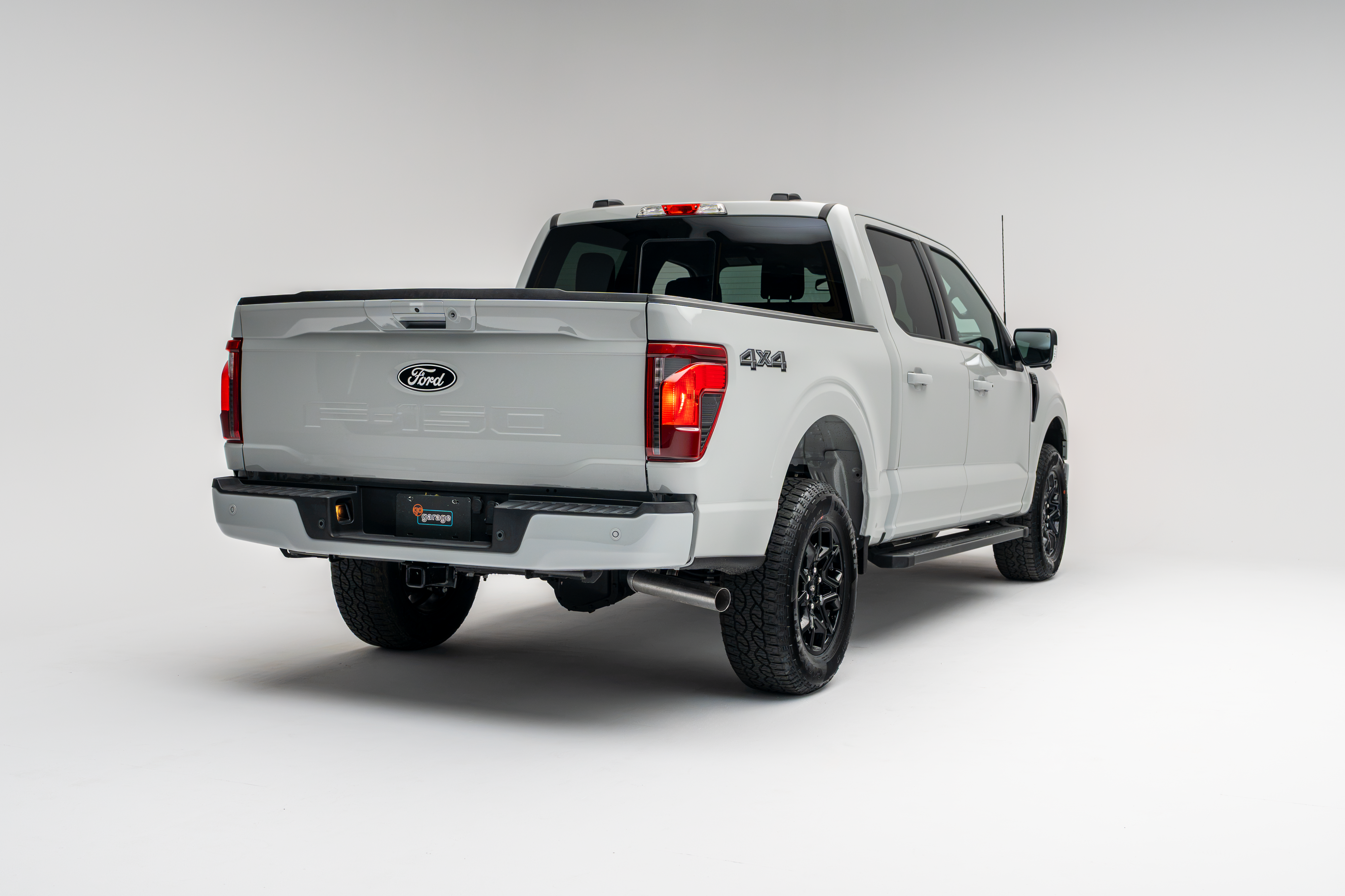 2026 Ford F-150 XLT white pickup truck rear three-quarter view