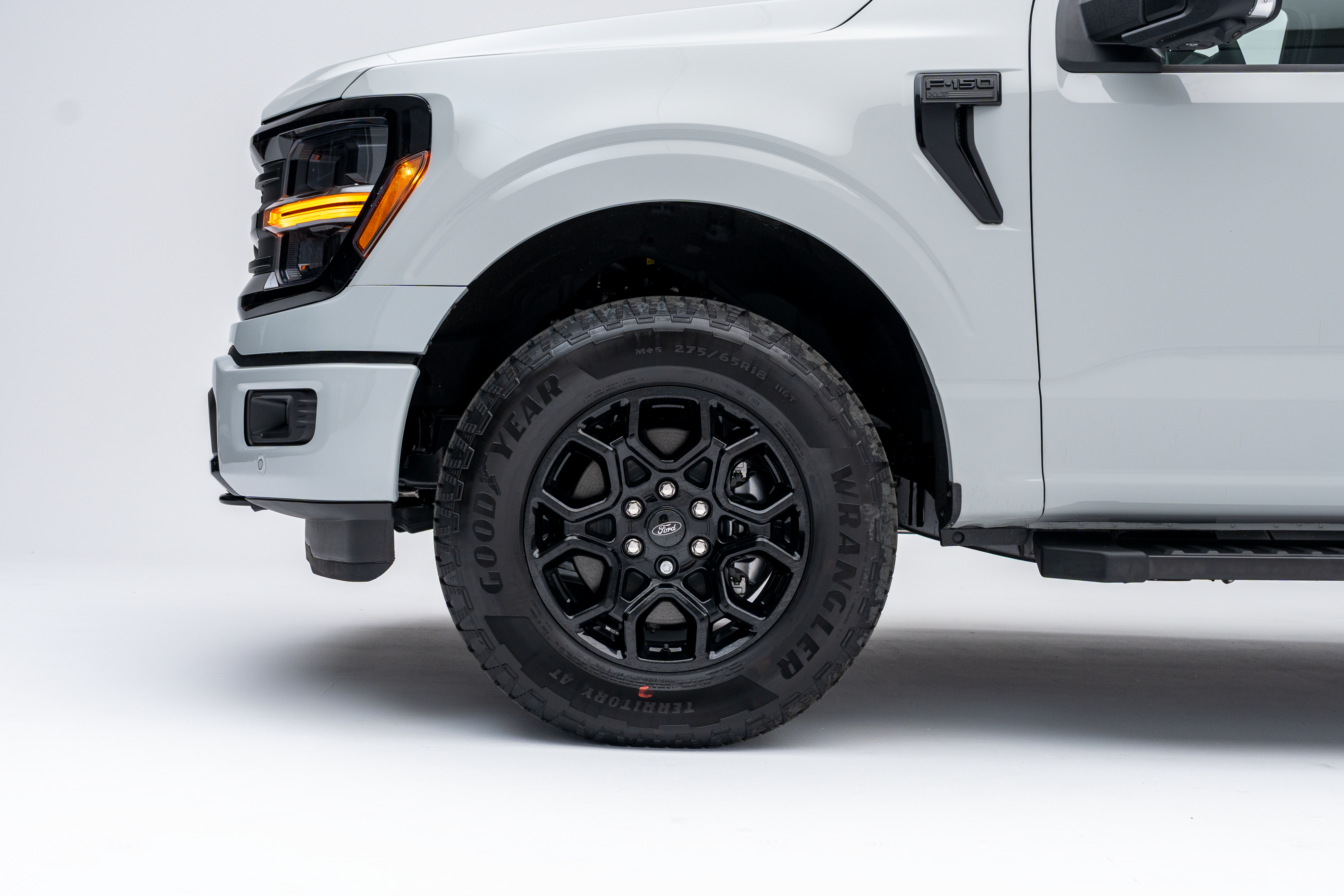 2026 Ford F-150 XLT front quarter view with LED headlights and all-terrain tire