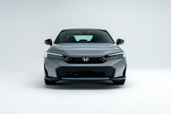 Front view of a grey 2026 Honda Civic showing LED headlights, grille and lower front fascia.
