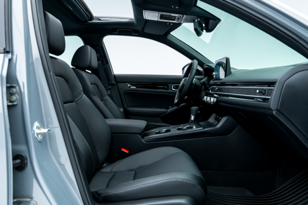 2026 Honda Civic front interior with black seats, centre console, dashboard and sunroof.