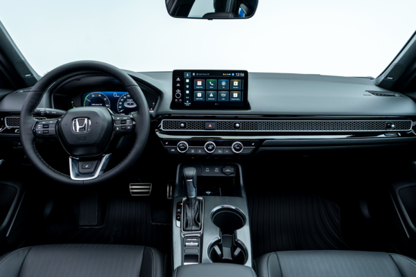 2026 Honda Civic interior with digital display, touchscreen, steering wheel and centre console.
