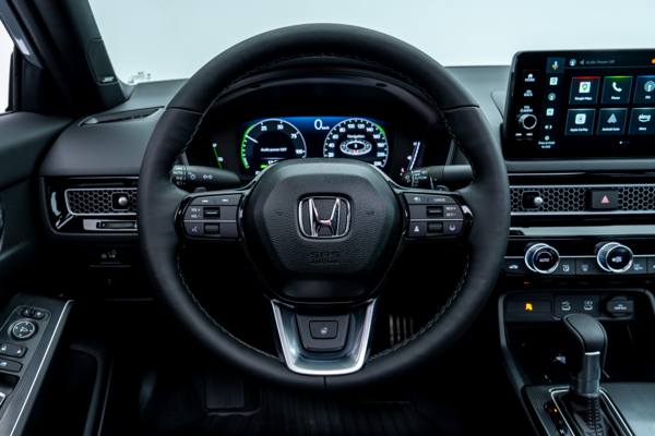 2026 Honda Civic driver view featuring the steering wheel, digital gauge cluster and touchscreen display.