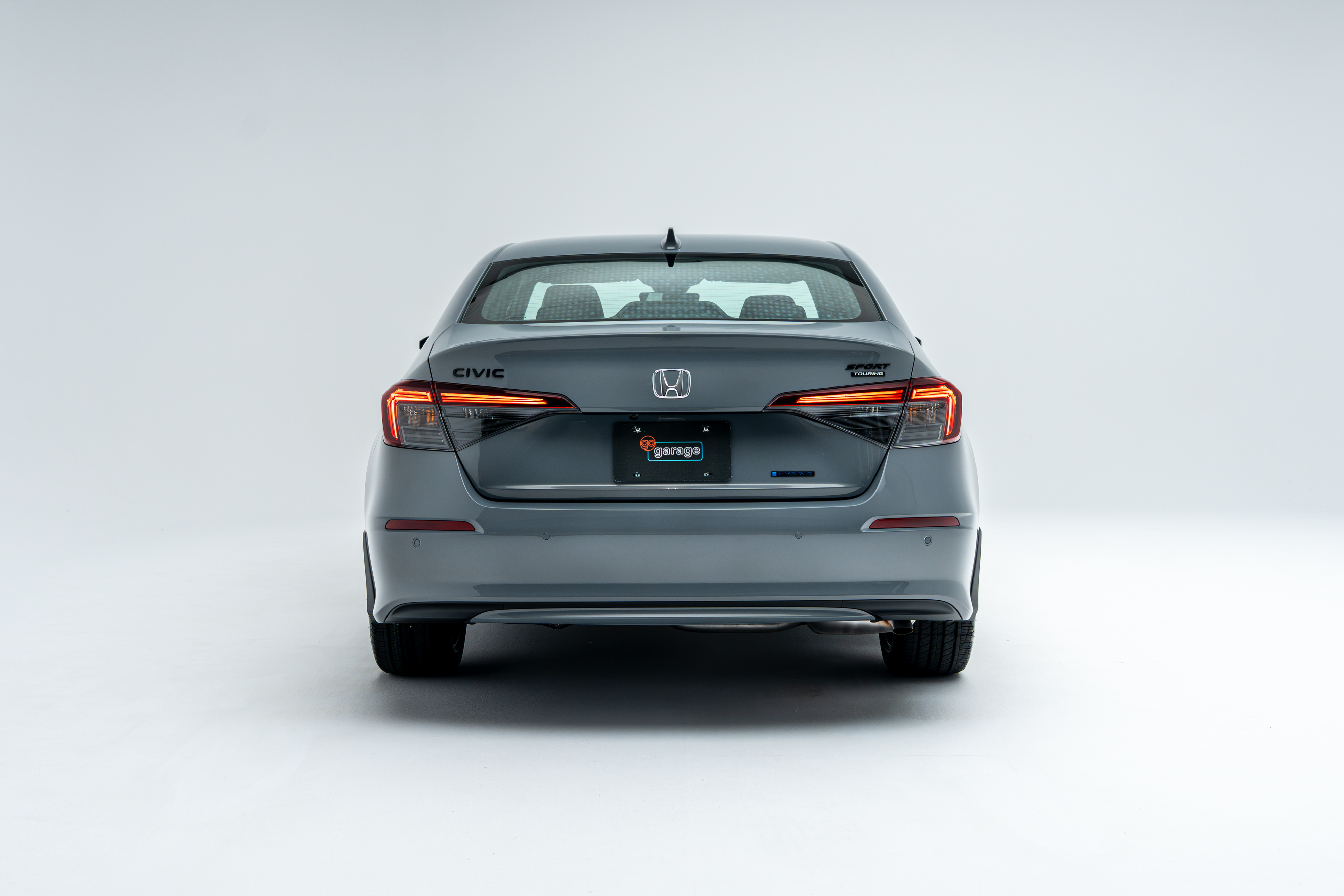 Rear view of a grey 2026 Honda Civic showing LED taillights and sedan design.