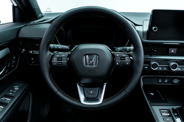 2026 Honda CR-V steering wheel with driver controls, digital instrument display and infotainment screen.