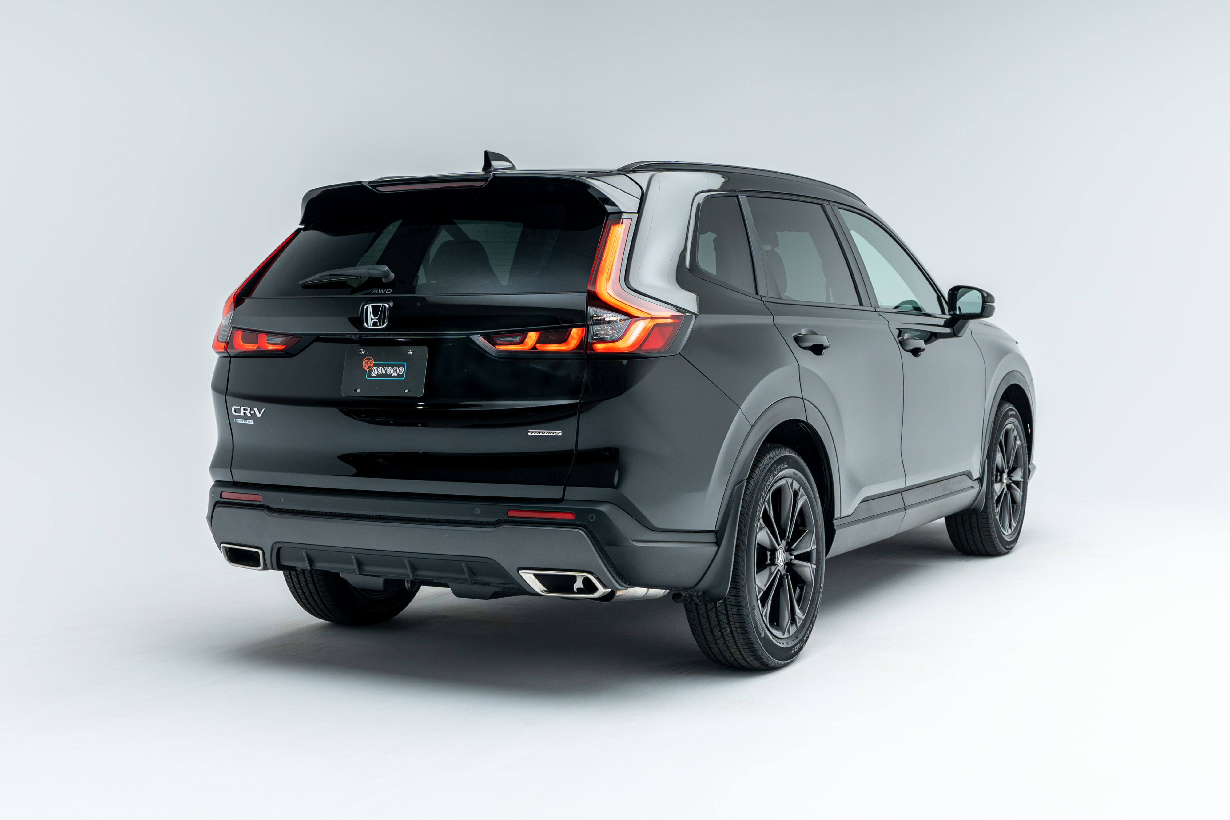 Rear three-quarter view of a black 2026 Honda CR-V showing LED taillights, alloy wheels and SUV profile.