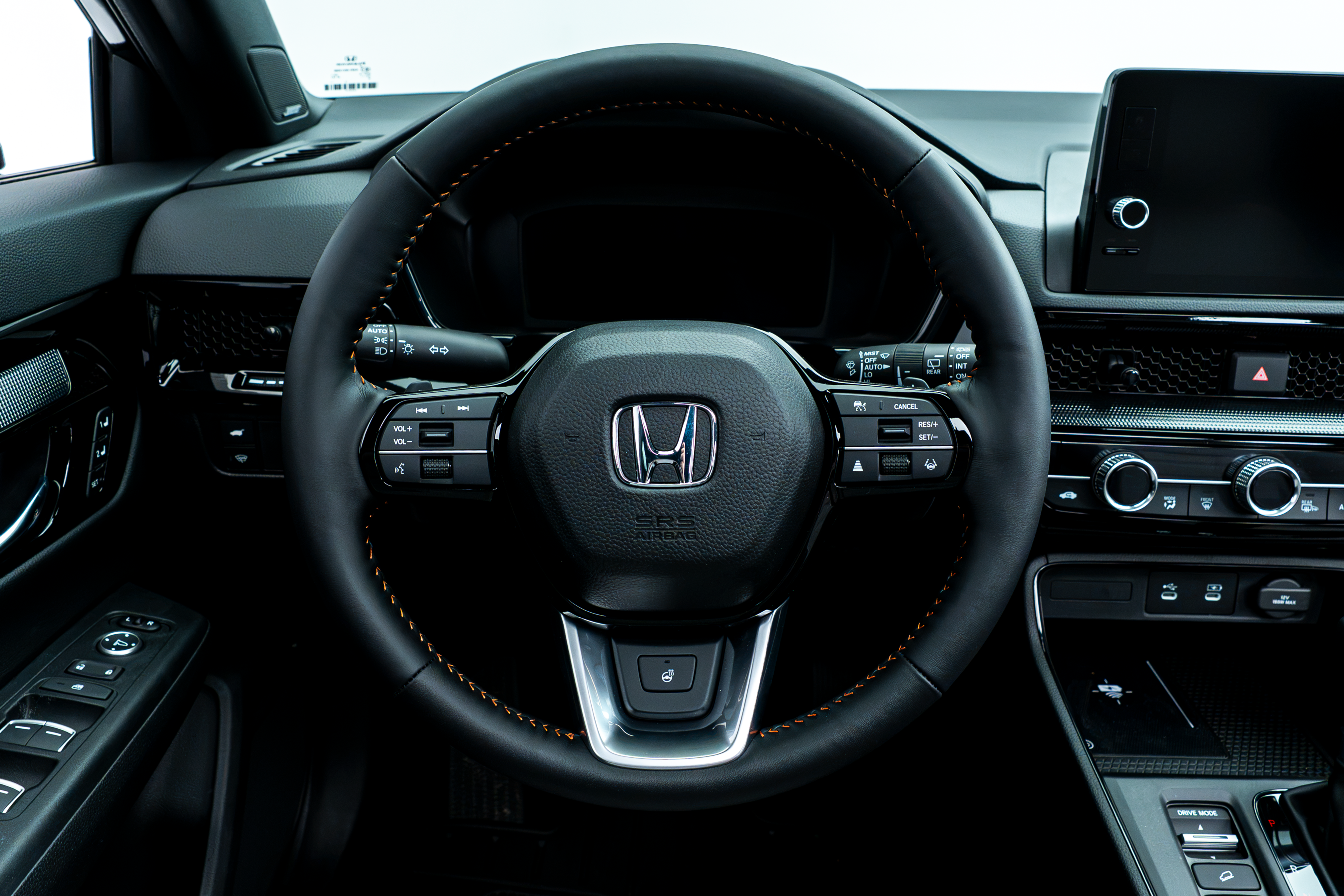 2026 Honda CR-V steering wheel with driver controls, digital instrument display and infotainment screen.