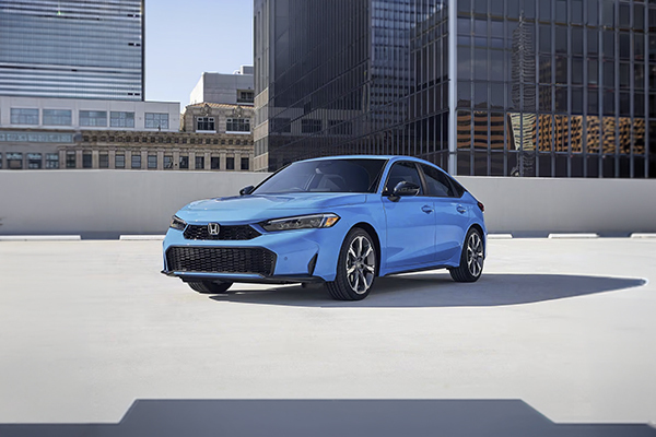 Blue Honda Civic sedan parked on urban rooftop with city skyline in background