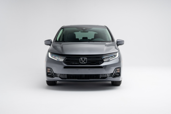 Front view of a grey 2026 Honda Odyssey Touring showing LED headlights, grille and front fascia.