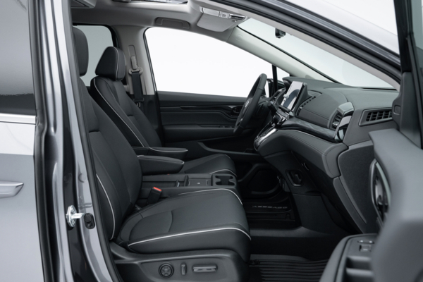 2026 Honda Odyssey Touring front interior with black seats, centre console, dashboard and sunroof.