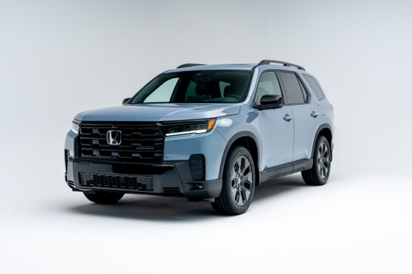 Front three-quarter view of a 2026 Honda Pilot showing LED headlights, grille, alloy wheels and SUV profile.