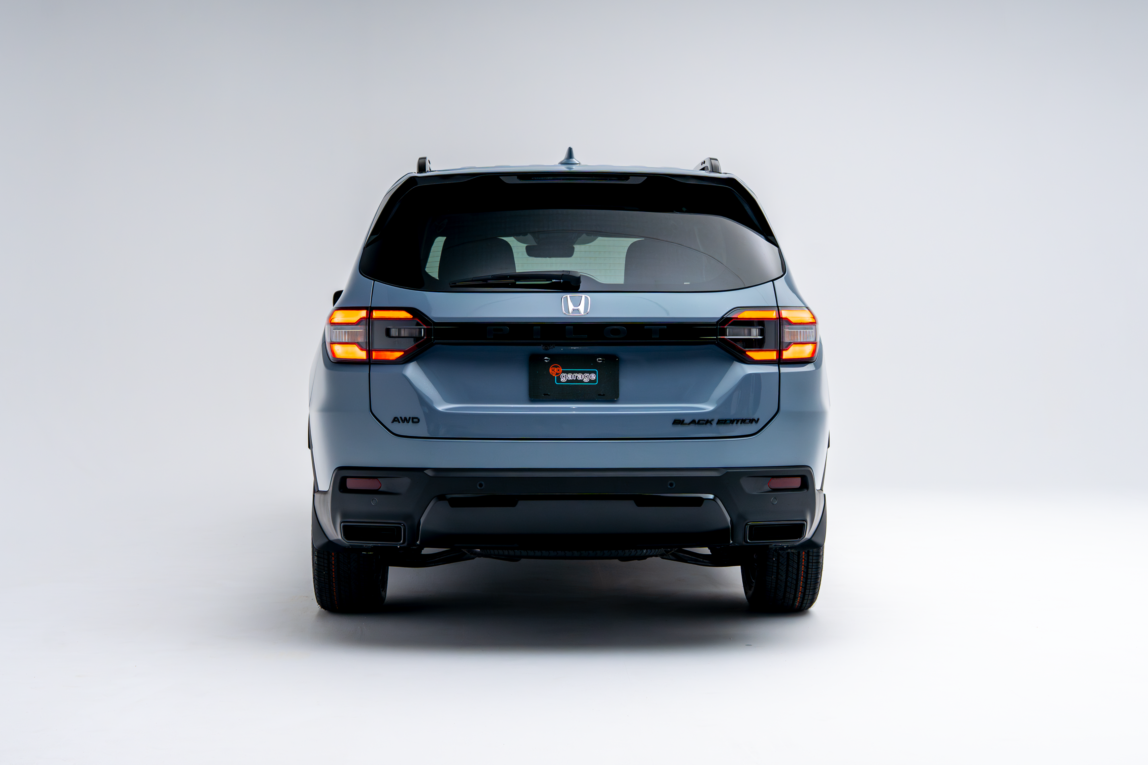 Rear view of a 2026 Honda Pilot showing LED taillights, Pilot badging and rear bumper.