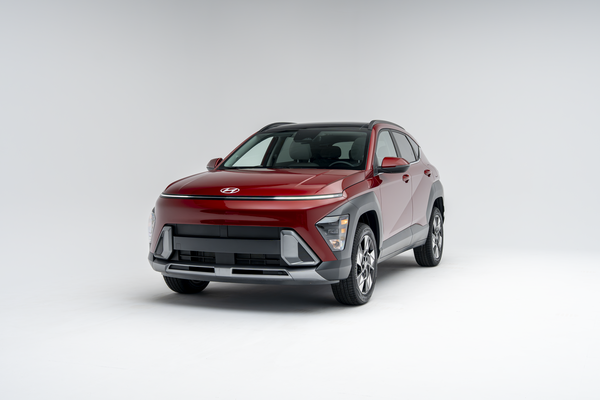 Front three-quarter view of a red 2026 Hyundai Kona SUV on a white studio background.