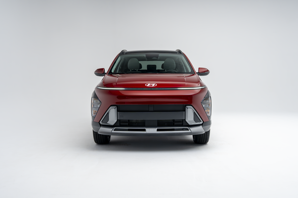 Front view of a red 2026 Hyundai Kona SUV on a white studio background.