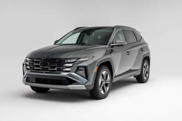 2026 Hyundai Tucson in grey, shown from a front three-quarter angle against a white studio background.
