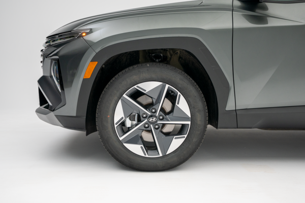 2026 Hyundai Tucson front wheel featuring a two-tone alloy rim and black tire.
