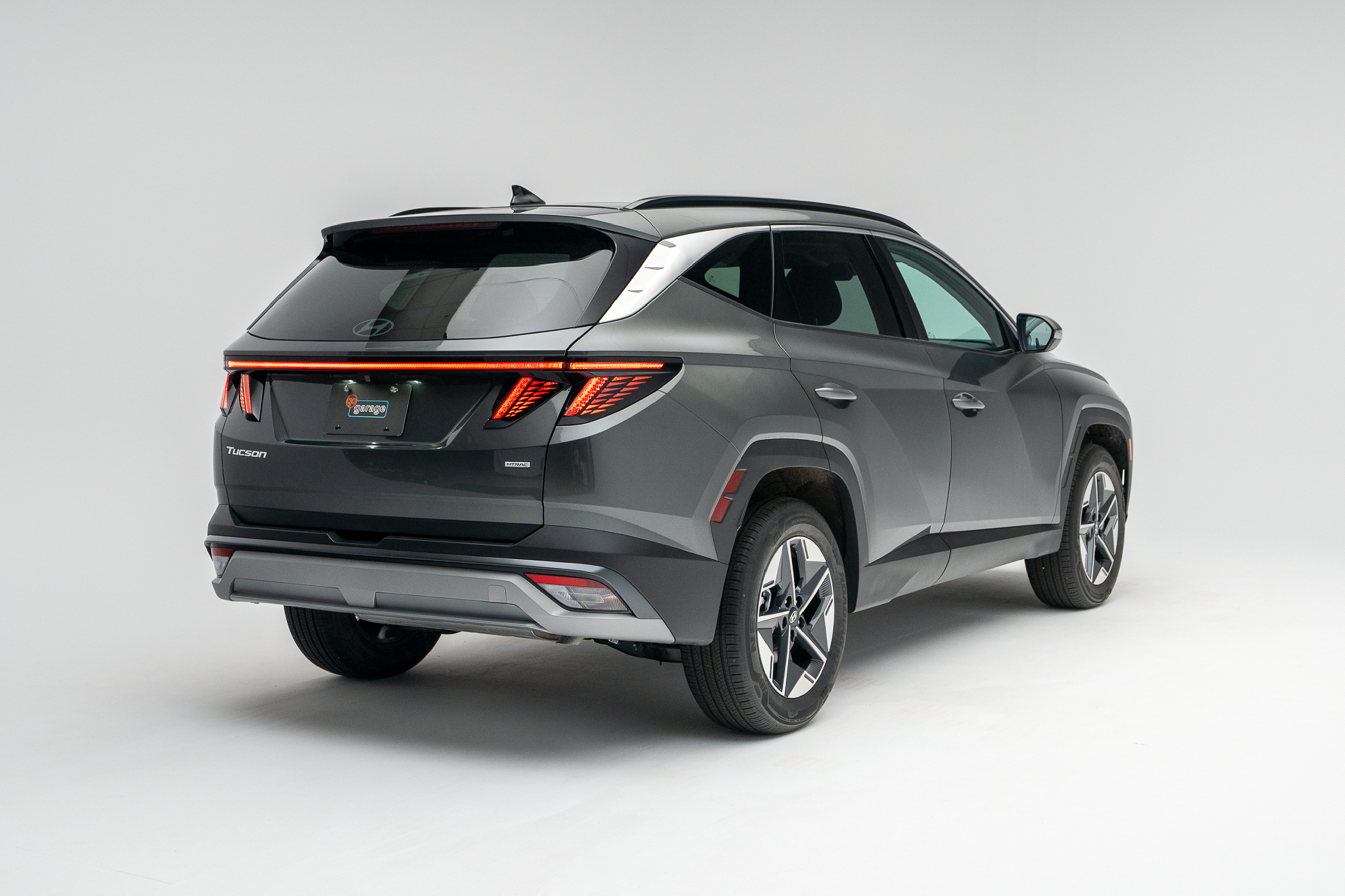 2026 Hyundai Tucson in grey, shown from a rear three-quarter angle against a white studio background.