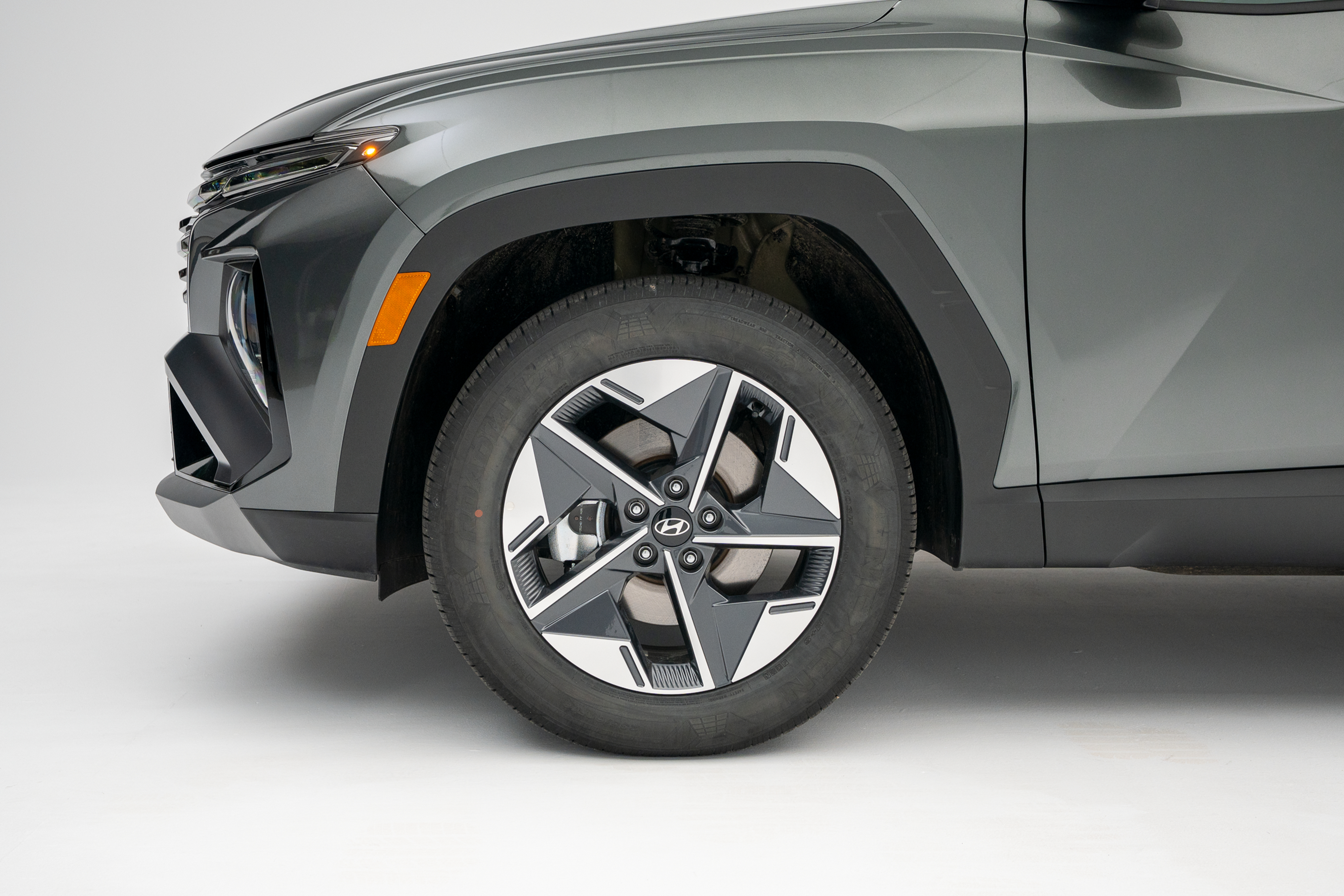 2026 Hyundai Tucson front wheel featuring a two-tone alloy rim and black tire.