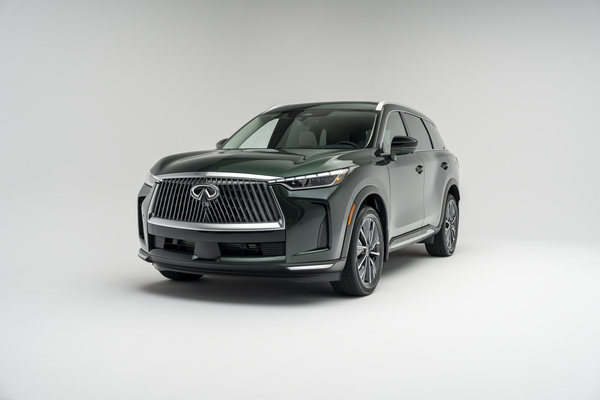 Front three-quarter view of a 2026 Infiniti QX60 showing LED headlights, grille, alloy wheels and SUV profile.