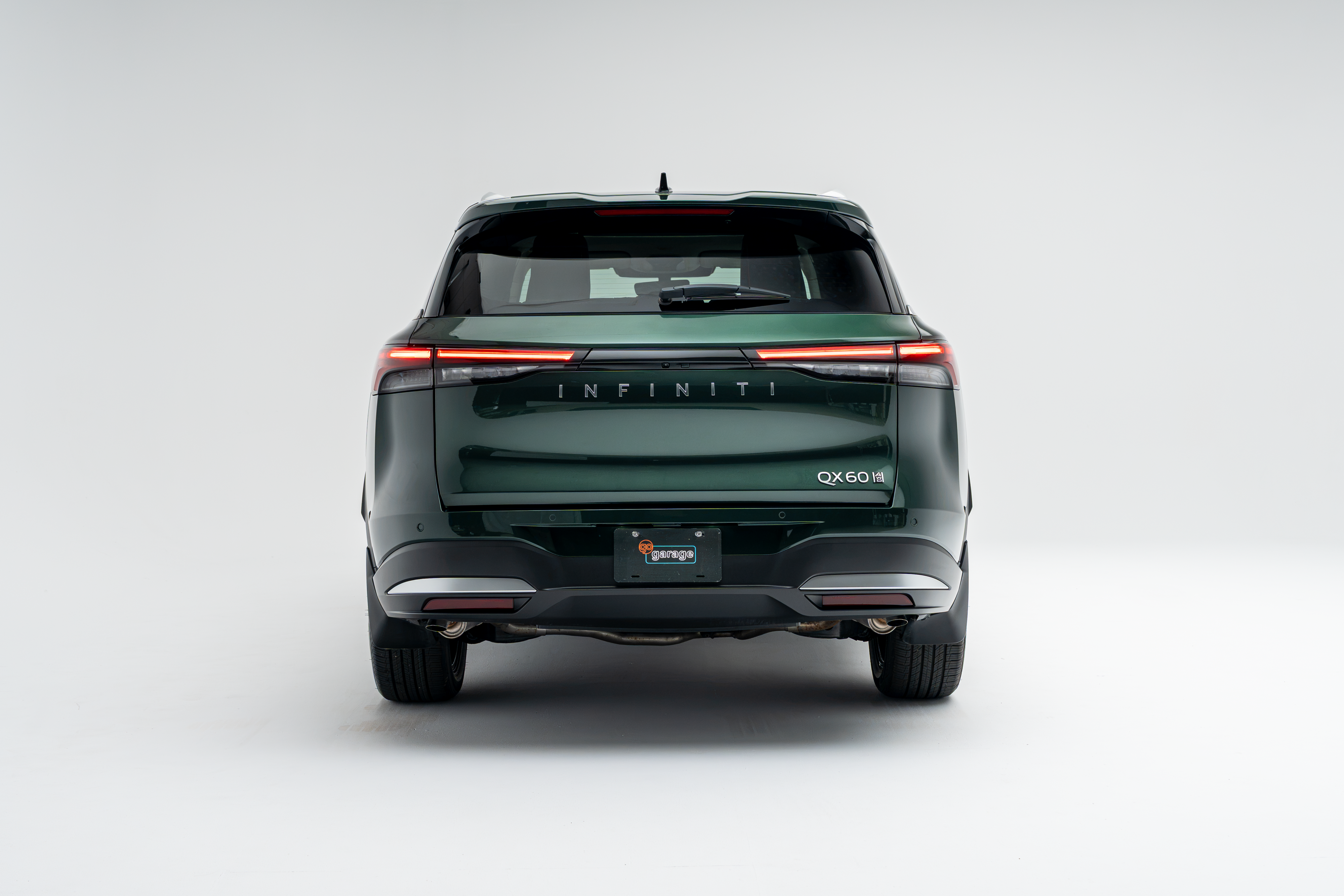 Rear view of a 2026 Infiniti QX60 showing LED taillights, QX60 badging and rear bumper.