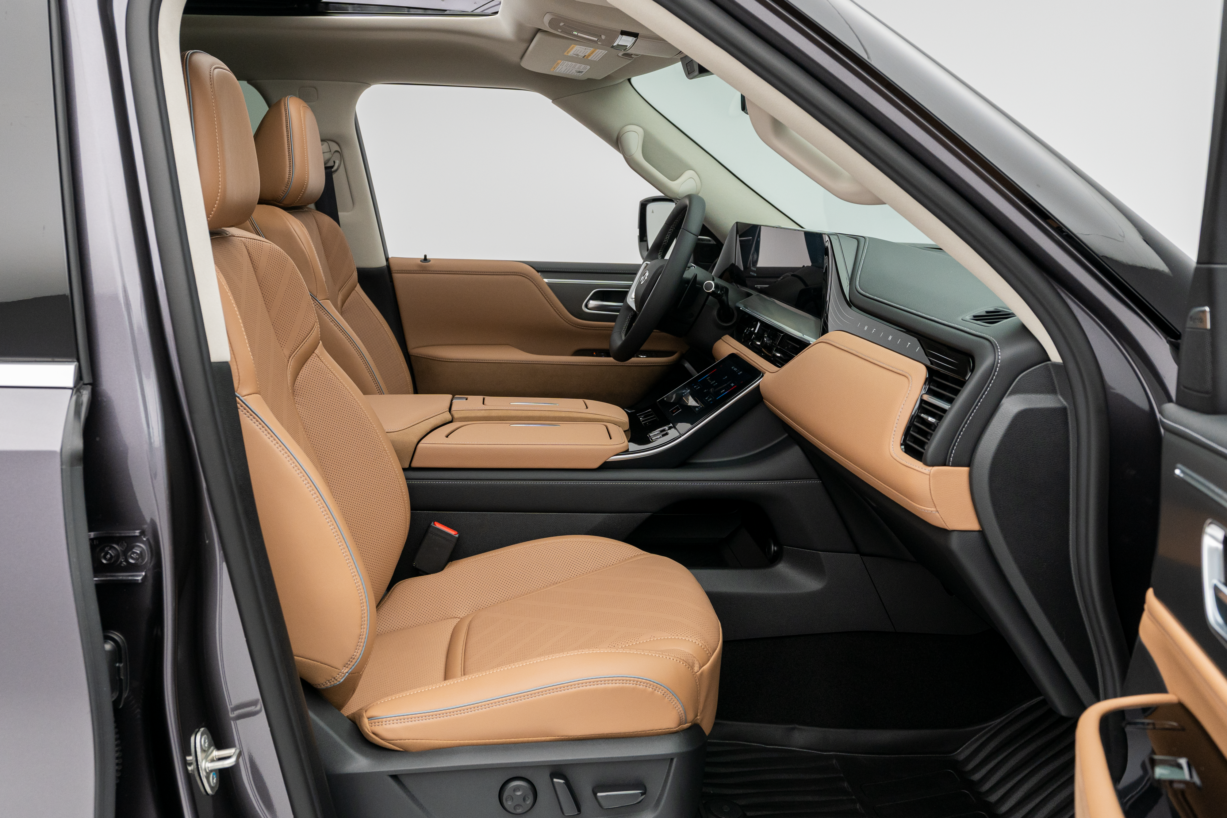 2027 INFINITI QX80 LUXE front passenger interior with quilted seating and centre console