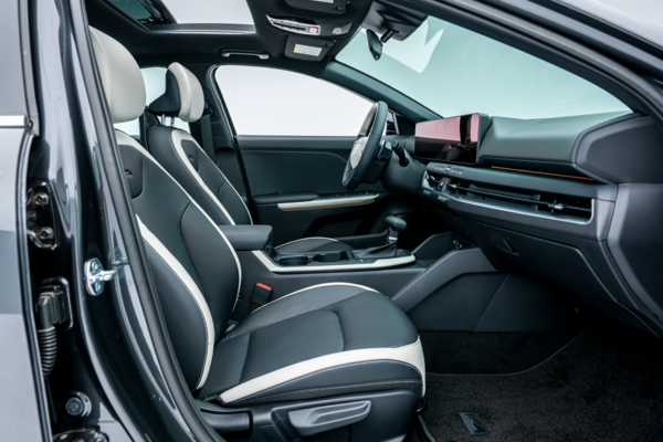 2026 Kia K4 front interior with two-tone seats, dashboard, centre console and sunroof.