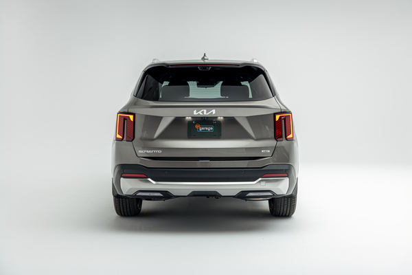 Rear view of a grey 2026 Kia Sorento showing LED taillights, Sorento badging and rear bumper.