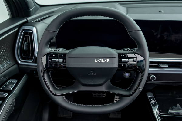 2026 Kia Sorento steering wheel with driver controls, digital instrument display and infotainment screen.