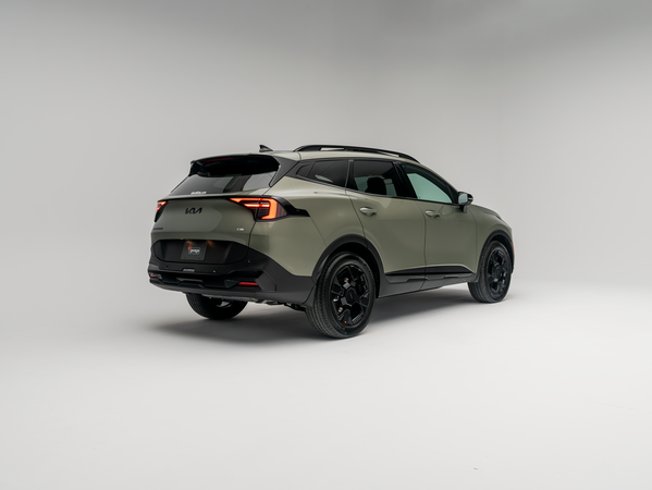 2026 Kia Sportage three-quarter rear view showing sage green exterior and black wheels