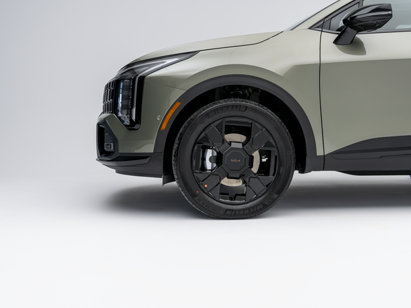 2026 Kia Sportage front quarter view showing grille, headlight, and wheel design