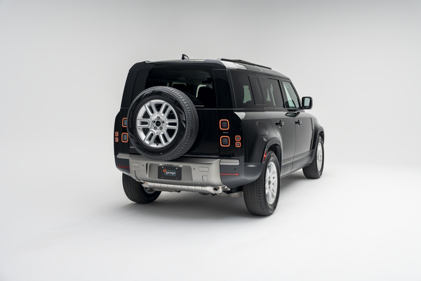 2026 Land Rover Defender 110 S rear three-quarter exterior view with rear-mounted spare tire