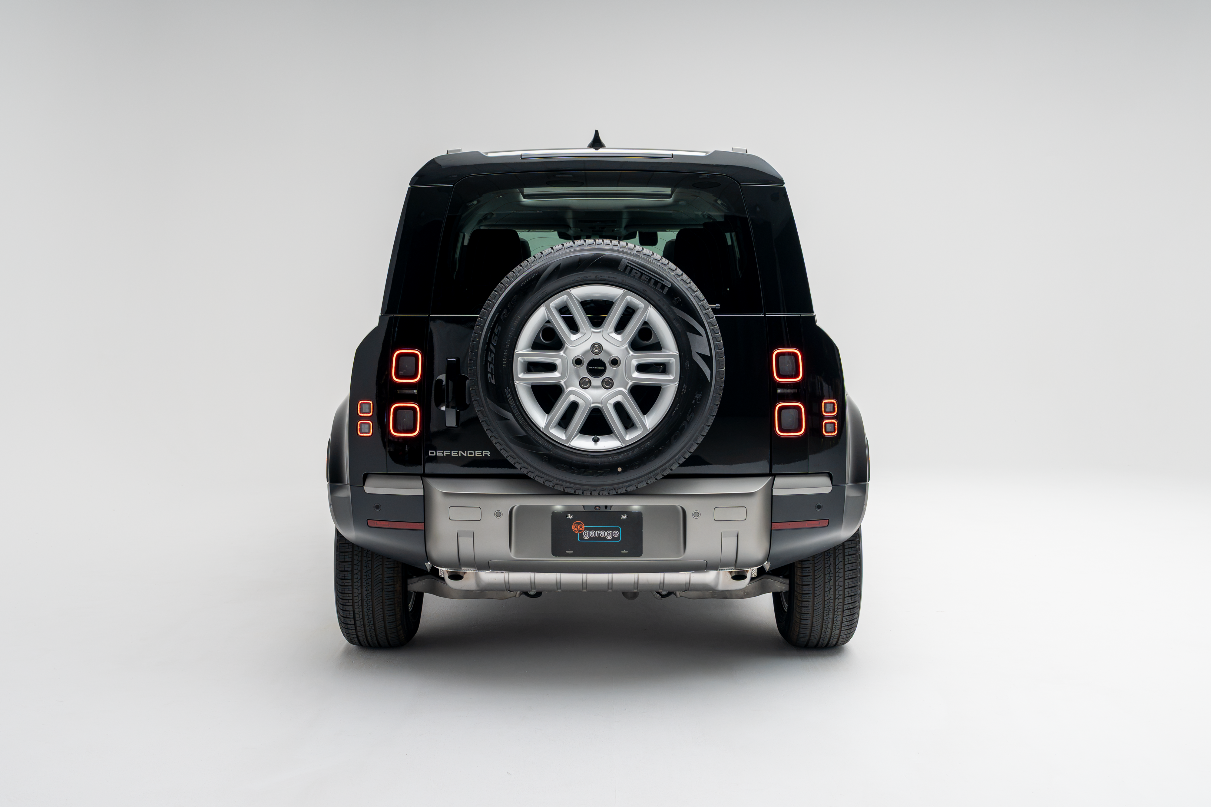 2026 Land Rover Defender 110 S rear view with spare tire and LED taillights