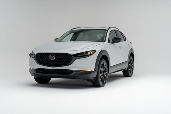 Front three-quarter view of a white 2026 Mazda CX-30 showing LED headlights, grille, alloy wheels and compact SUV profile.