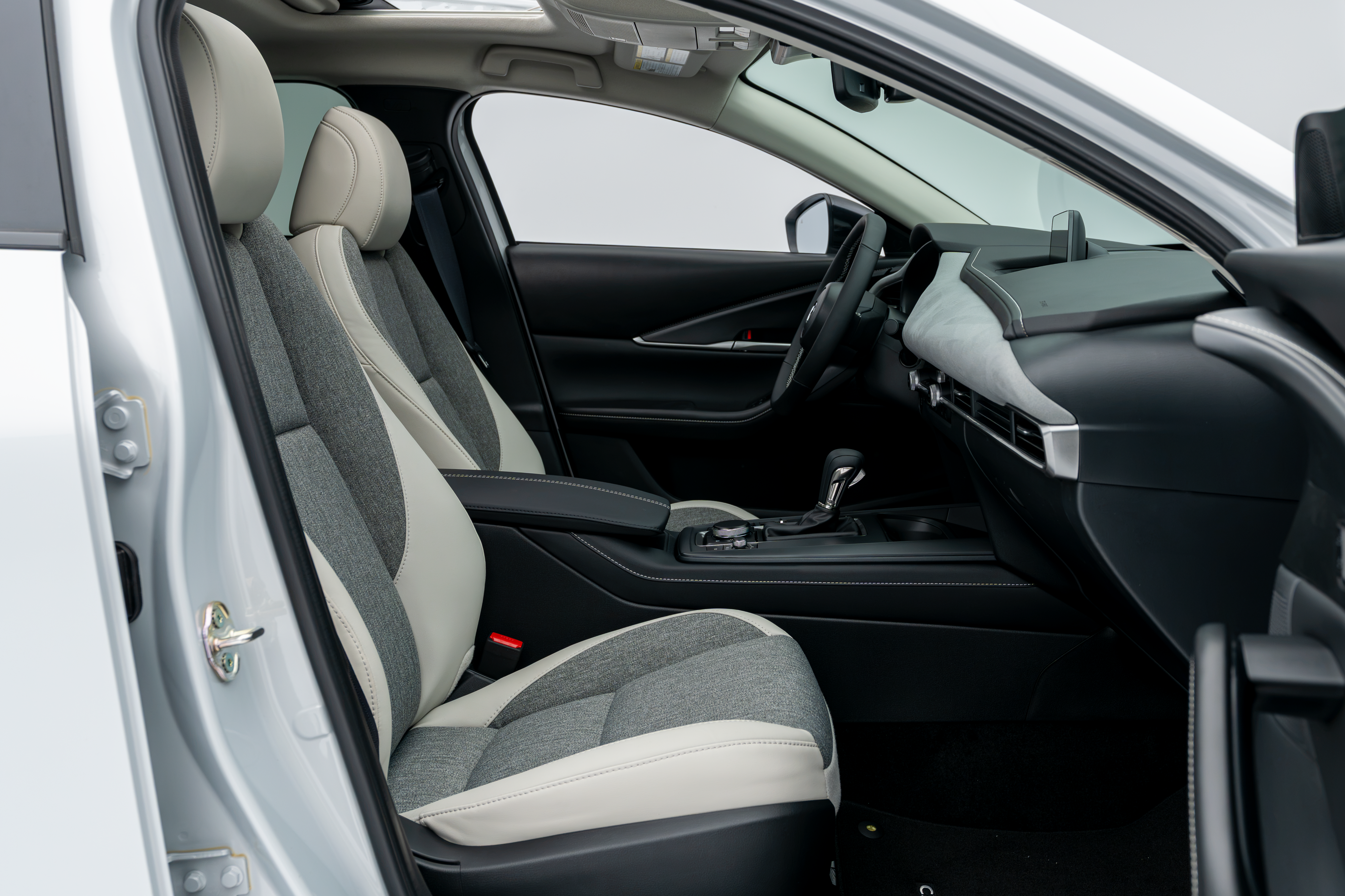 2026 Mazda CX-30 front interior with two-tone seats, dashboard, centre console and sunroof.