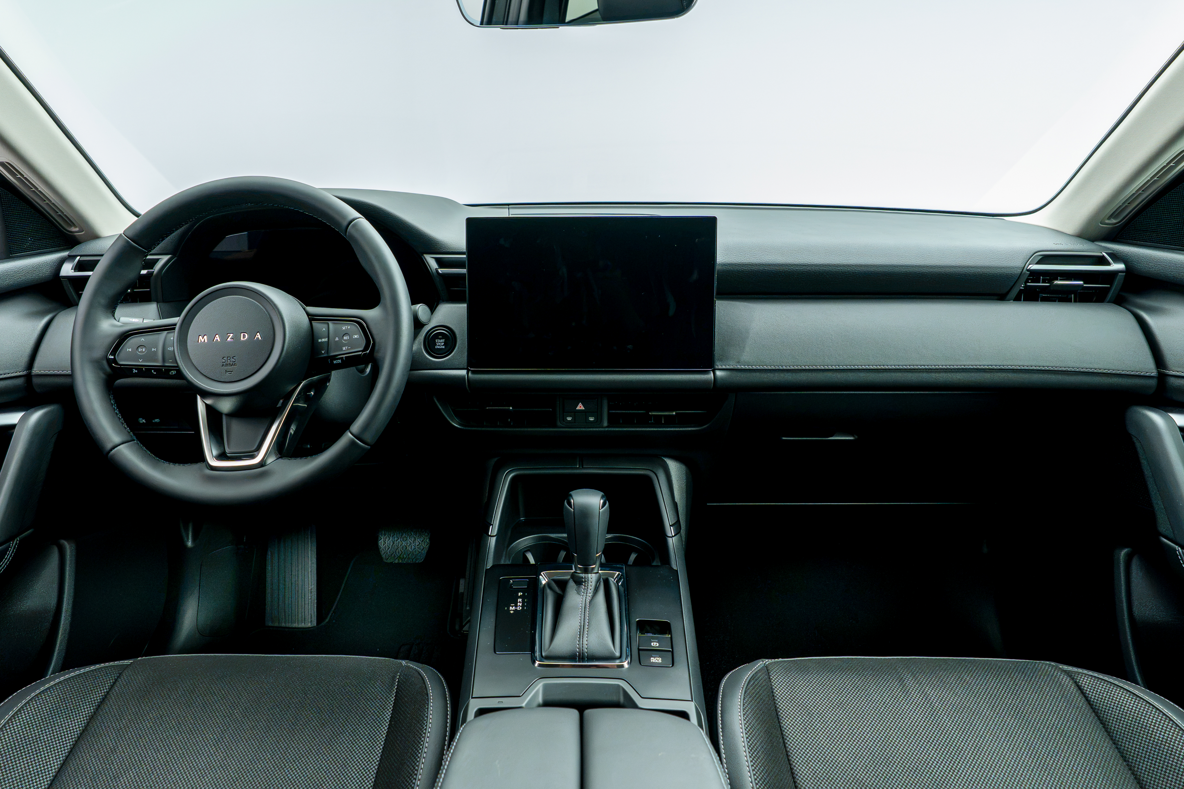 2026 Mazda CX-5 front interior with black seats, dashboard, centre console and infotainment display.