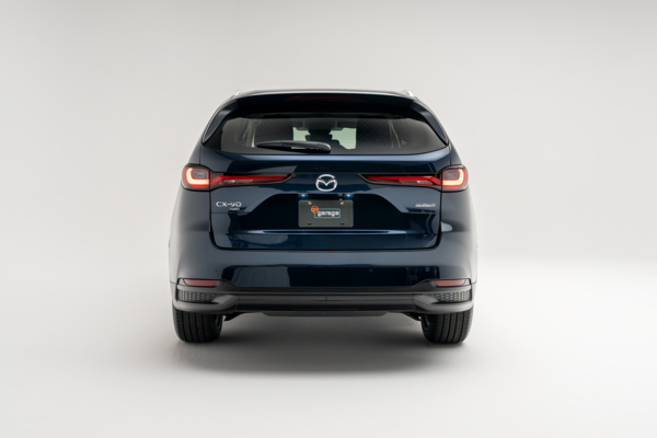 Rear view of a blue 2026 Mazda CX-90 showing LED taillights, CX-90 badging and rear bumper.