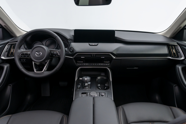 2026 Mazda CX-90 interior dashboard with steering wheel, infotainment display, centre console and front seats.